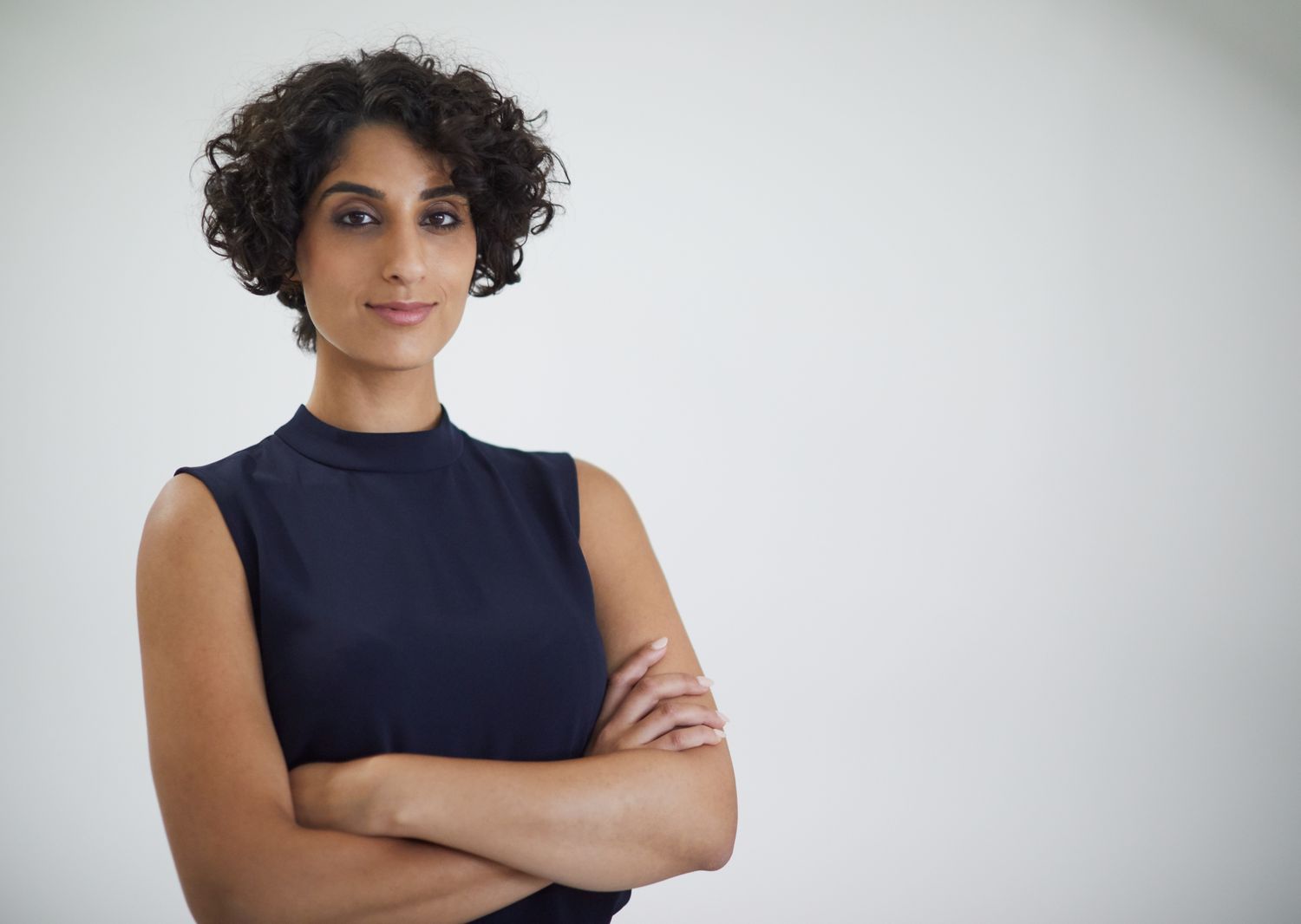 Studio headshot of confident businesswoman looking at camera.