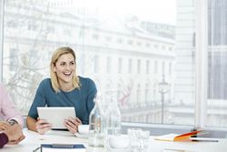 Business woman working on a digital tablet.